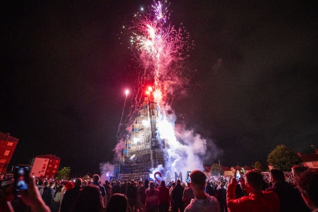 People watch the burning of the loyalist Corcrain bonfire in Portadown, Co Armagh