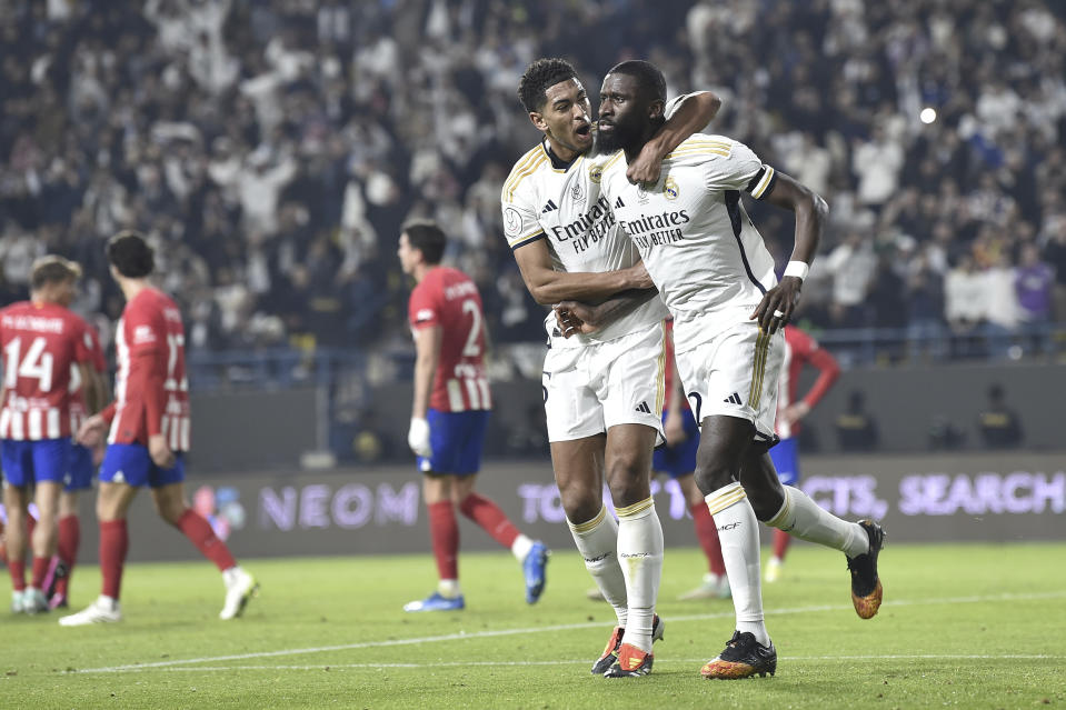 Real Madrid's Antonio Rudiger, right, celebrates scoring their first goal with Jude Bellingham during the Semi Final of Spanish Super Cup match between Real Madrid and Atletico Madrid at Al Awal Park Stadium in Riyadh, Saudi Arabia, Wednesday, Jan. 10, 2024. (AP Photo)