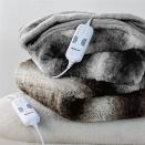 <p>Embrace those luxe vibes with something plush and fabulous like this <span> Bedsure Faux Fur Low Voltage Heated Blanket</span> ($73-$80). It's 50 inches long and 60 inches wide. It has four heat settings with a four hour auto-shut off timers. It comes in brown and grey, perfect for adding a skii resort vibe to your home.</p>