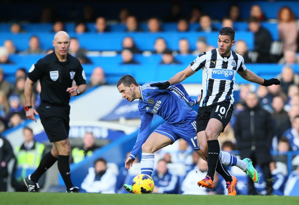 Chelsea's Eden Hazard, left, pushed off the ball by Newcastle's Hatem Ben Arfa during their English Premier League soccer match between Chelsea and Newcastle United in London, Saturday, Feb. 8, 2014. (AP Photo/Alastair Grant)