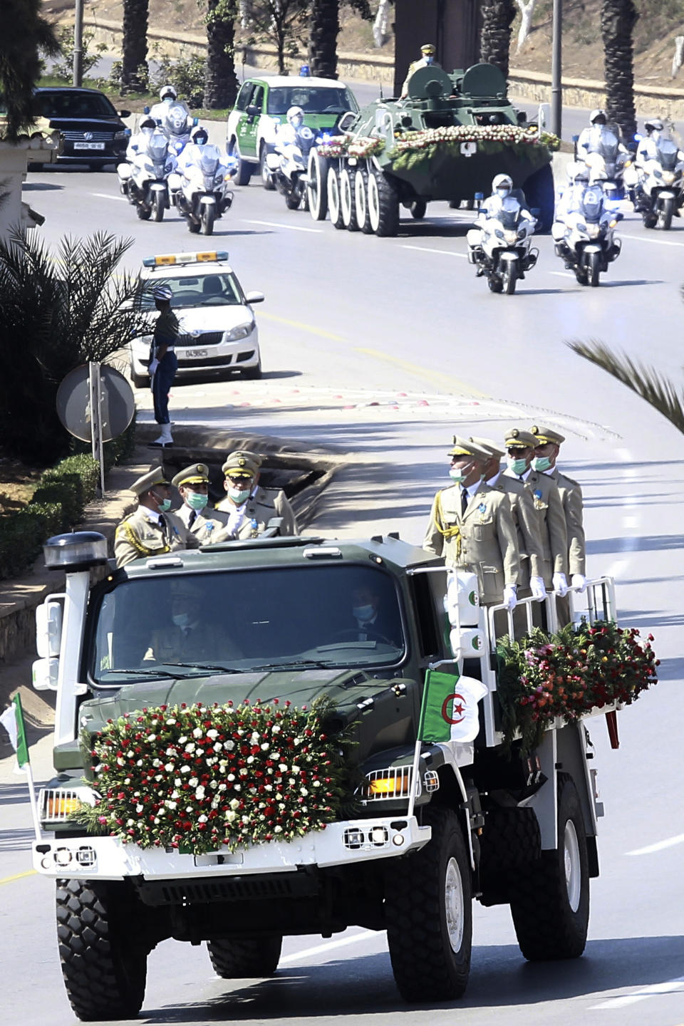 The convoy carrying the coffin of former Algerian President Abdelaziz Bouteflika drives on its way to the El Alia cemetery in Algiers, Sunday, Sept.19, 2021. Algeria's leader declared a three-day period of mourning starting Saturday for former President Abdelaziz Bouteflika, whose 20-year-long rule, riddled with corruption, ended in disgrace as he was pushed from power amid huge street protests when he decided to seek a new term. Bouteflika, who had been ailing since a stroke in 2013, died Friday at 84. (AP Photo/Fateh Guidoum)