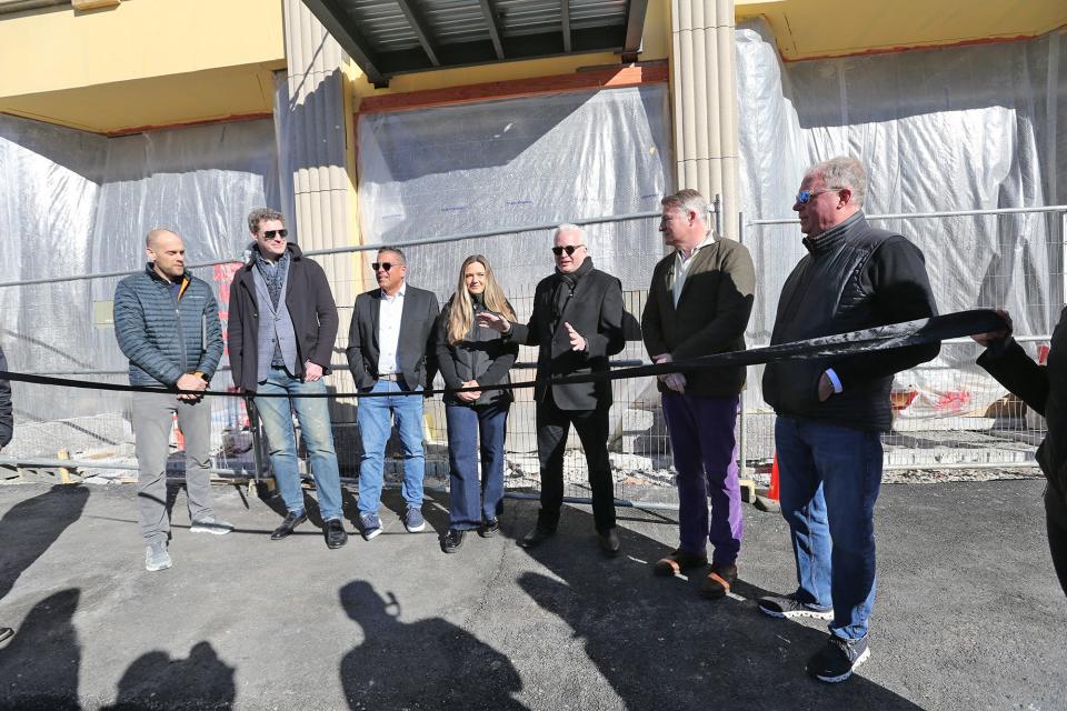 Scott Rome of Brick & Barn | Compass, the leasing agency for The Howard, says a few words before the official ribbon cutting in Rochester Wednesday, Feb. 7, 2024. From left are David Groen of Groen Construction, developer Paul Grant, Joey Giordano of Brick & Barn, residential leasing agent Maggie Getman, developer Greg Grant and commercial space leasing agent Bob Marchewka.