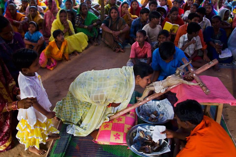 A Christian woman kisses the feet of a statue of Jesus Christ during Good Friday services in the village of Mondesore near Raikia, Odisha, India.