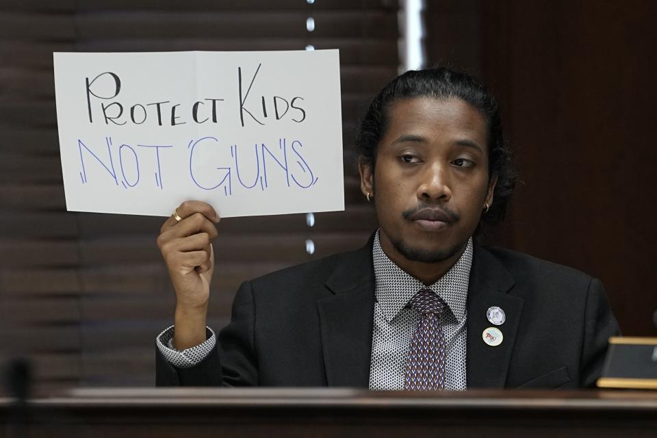 Rep. Justin Jones, D-Nashville, holds a sign in the House Civic Justice Committee of 1st Extraordinary Session meeting during a special session of the state legislature on public safety on Wednesday, Aug. 23, 2023, in Nashville, Tenn. | George Walker IV, Associated Press