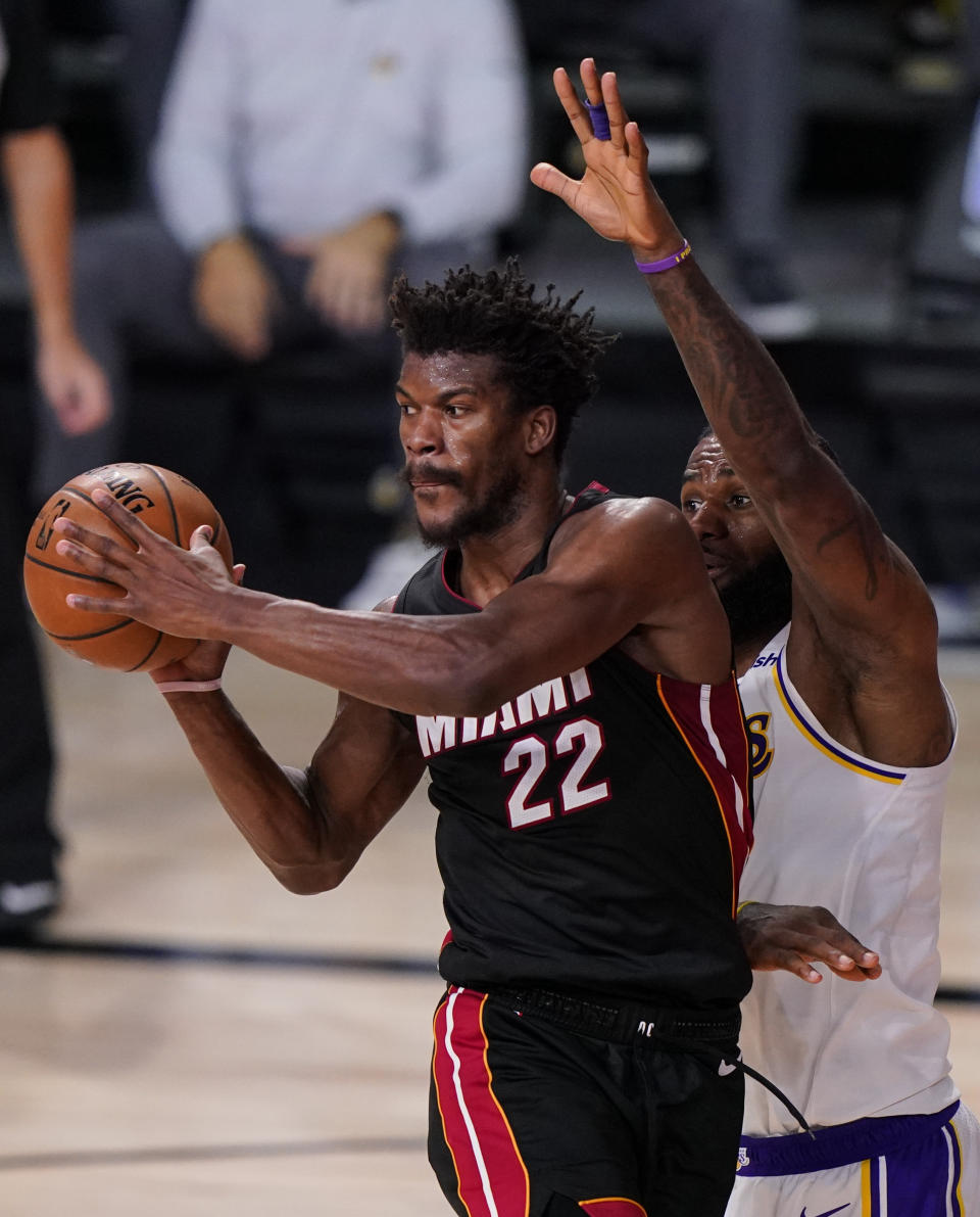 Miami Heat's Jimmy Butler (22) passes the ball against Los Angeles Lakers' LeBron James (23) during the second half in Game 3 of basketball's NBA Finals, Sunday, Oct. 4, 2020, in Lake Buena Vista, Fla. (AP Photo/Mark J. Terrill)