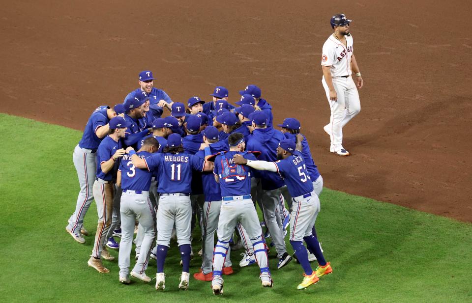 ALCS Game 7: Rangers players celebrate on the field after the win.