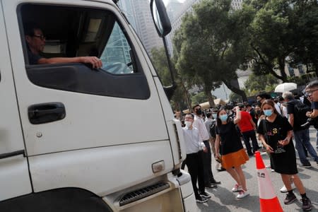 Demonstrators block a street during a protest against what they say is the abuse of pro-democracy protesters by Hong Kong police, at Chater Garden in Central district, Hong Kong