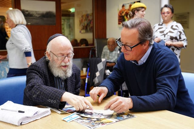 Foreign Secretary Lord David Cameron speaks to Wilfred Lazarus during a visit to The Fed, a social care charity for the Jewish community, in Manchester 