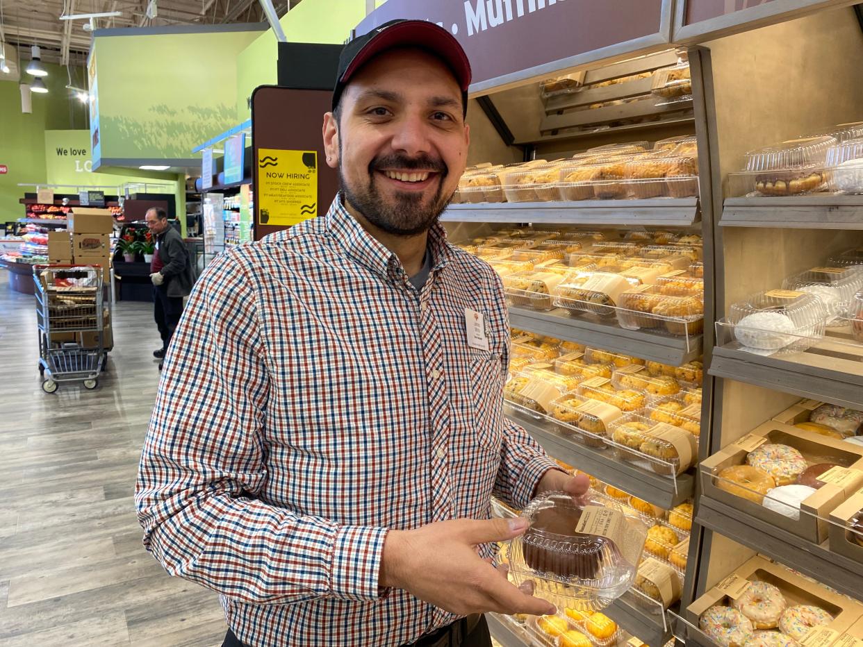 Taunton Hannaford Supermarket Store Manager James White on Jan. 12, 2024, picks out his favorite dessert from the upgraded desserts area, much of which comes from local pastry vendors.