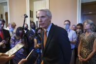 Sen. Rob Portman, R-Ohio, the lead GOP negotiator on the infrastructure talks, talks to reporters as he announces a $1 trillion infrastructure agreement with Democrats and is ready to vote to take up the bill, at the Capitol in Washington, Wednesday, July 28, 2021. (AP Photo/J. Scott Applewhite)