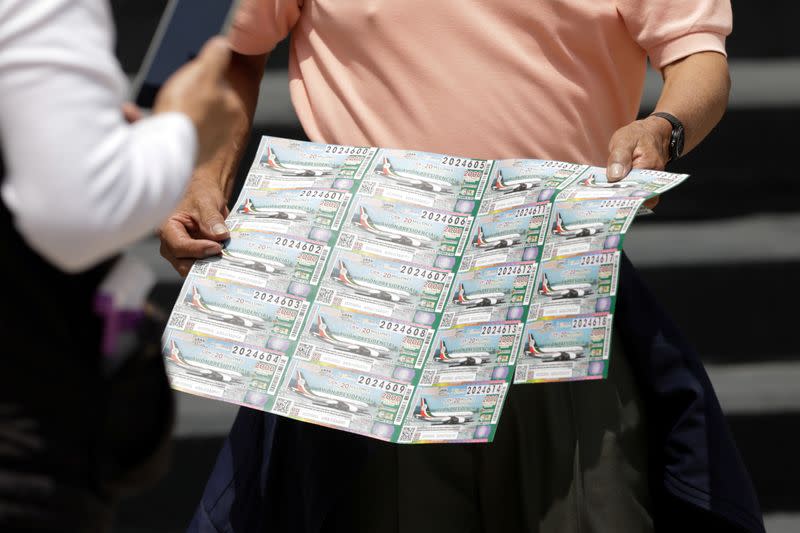 A person holds lottery tickets for the raffle of a presidential luxury jet, organised by the Mexico's government to raise money equivalent to the value of the airplane, outside the National Lottery building in Mexico City