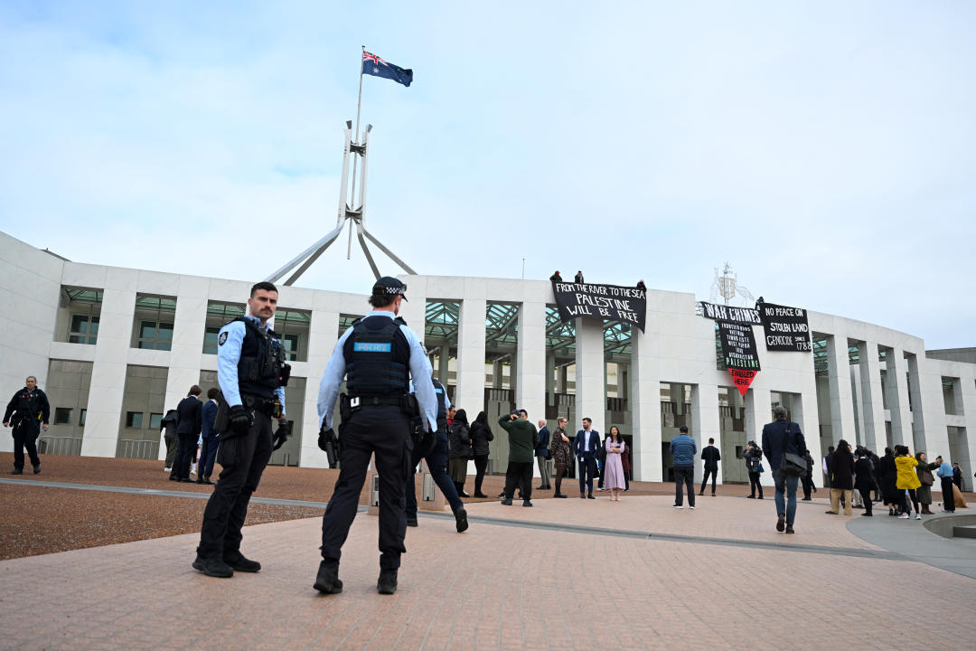 Pro-Palestine protesters hang banners from the top of Parliament House on Thursday. Source: AAP