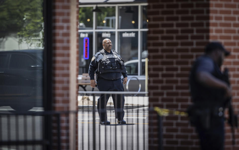 A Memphis police negotiator waits for an ambulance to arrive on the scene of an active shooter near the University of Memphis, Tuesday, May 2, 2023. (Patrick Lantrip/Daily Memphian via AP)