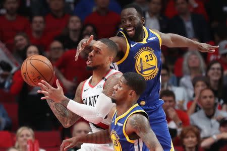 May 20, 2019; Portland, OR, USA; Portland Trail Blazers guard Damian Lillard (0) passes the ball past the hand of Golden State Warriors forward Draymond Green (23) in the second half of game four of the Western conference finals of the 2019 NBA Playoffs at Moda Center. Mandatory Credit: Jaime Valdez-USA TODAY Sports