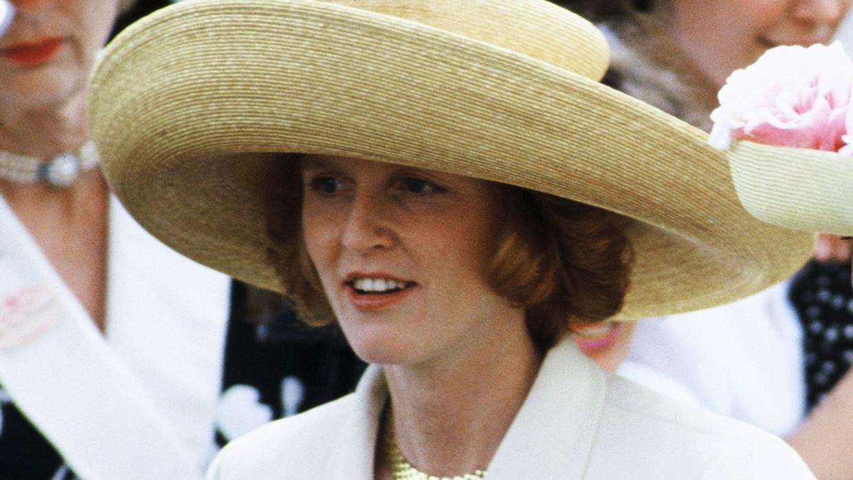 Sarah Ferguson in a white suit and wide-brim hat