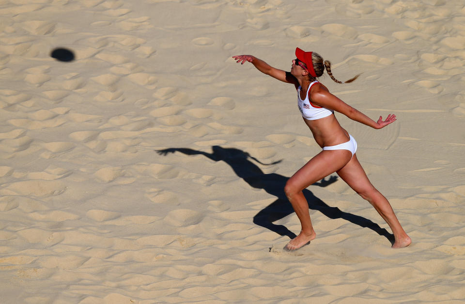 LONDON, ENGLAND - AUGUST 03: April Ross of the United States serves during the Women's Beach Volleyball Round of 16 match between United States and Switzerland on Day 7 of the London 2012 Olympic Games at Horse Guards Parade on August 3, 2012 in London, England. (Photo by Ryan Pierse/Getty Images)