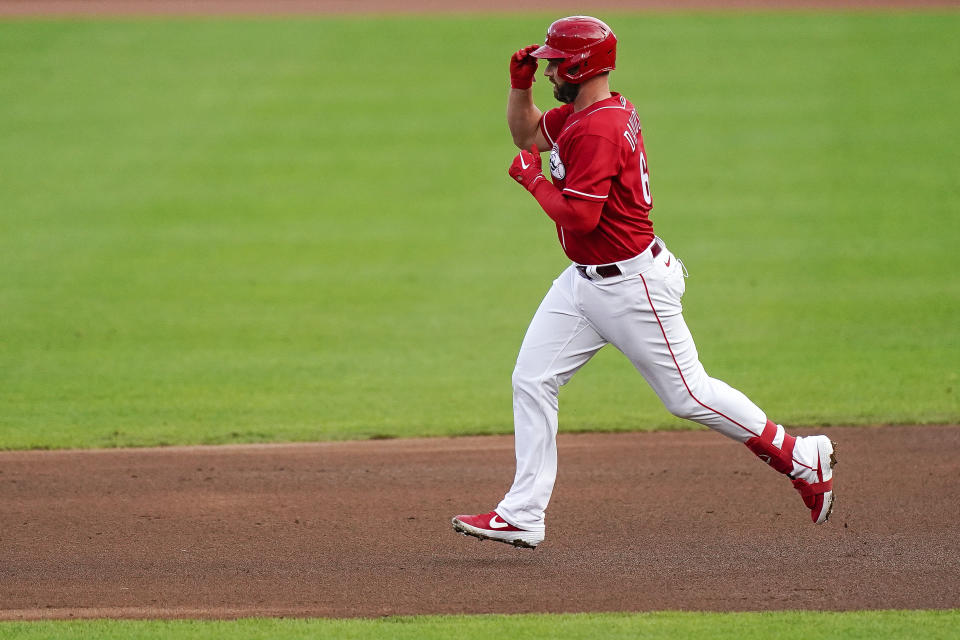 Cincinnati Reds infielder Matt Davidson touches his cap as he runs the bases after hitting a home run in the fourth inning of the exhibition baseball game against the Detroit Tigers at Great American Ballpark in Cincinnati, Wednesday, July 22, 2020. (AP Photo/Bryan Woolston)