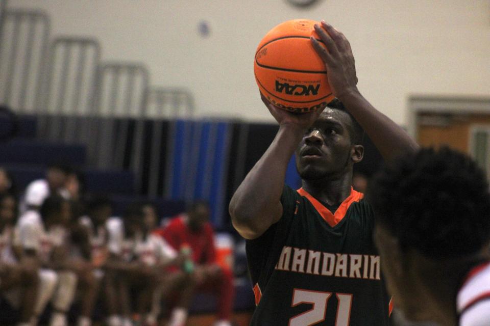 Mandarin center Dylan McCleod (21) lines up a free throw against Jackson.