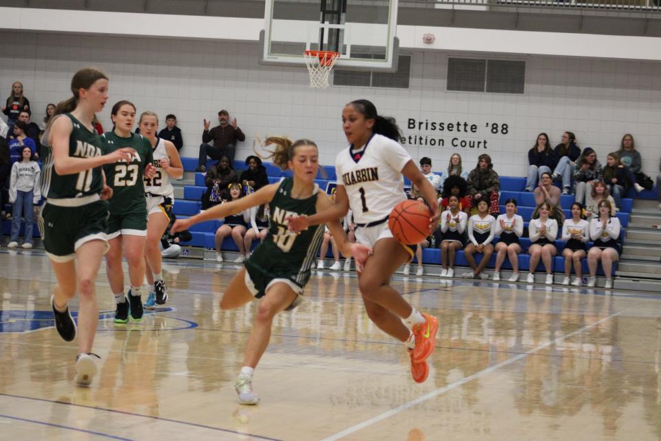 Point guard Mia Ducos works to dribble around NDA's Ava Leahy, who fouled out for her intense defense against Ducos throughout the game. Quabbin defeated NDA to win the Class B Central Mass. final at Worcester State on February 21, 2024.