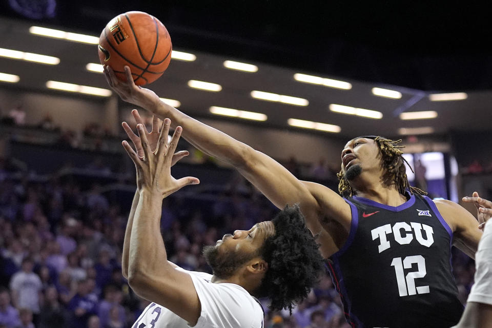 TCU forward Xavier Cork (12) beats Kansas State forward Will McNair Jr. to a rebound during the first half of an NCAA college basketball game Saturday, Feb. 17, 2024, in Manhattan, Kan. (AP Photo/Charlie Riedel)