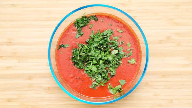 red enchilada sauce with cilantro garnish