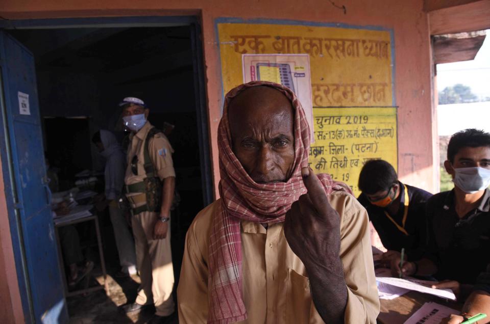 A man displays the indelible ink mark on his finger after casting his vote at a polling station, during the first phase of state elections at Paliganj, in the eastern Indian state of Bihar, Wednesday, Oct. 28, 2020. With an overall declining coronavirus positive trend, Indian authorities decided to hold the first state legislature election since the outbreak of COVID-19. People began voting Wednesday in the country’s third largest state Bihar with of a population of about 122 million people. (AP Photo/Aftab Alam Siddiqui)