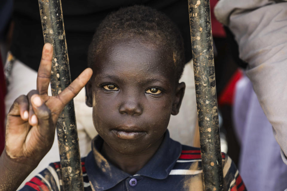 FILE - in this July 18, 2019 file photo, a boy flashes the victory sign during a protest condemning a deadly crackdown last month in Khartoum, Sudan. (AP Photo/Mahmoud Hjaj, File)