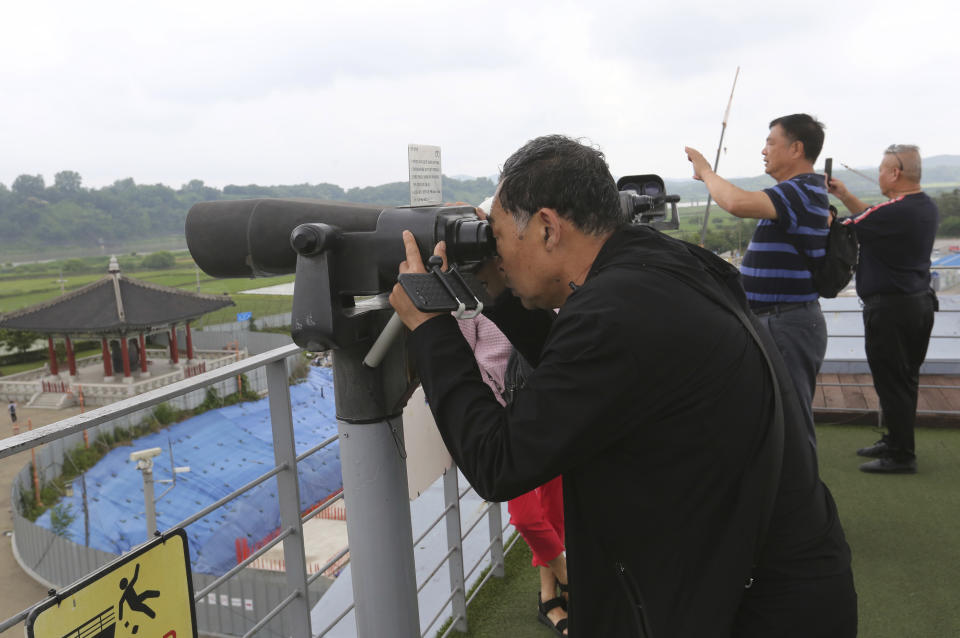 Chinese visitors look toward the North's side at the Imjingak Pavilion, near the demilitarized zone of Panmunjom, in Paju, South Korea, Thursday, June 20, 2019. Chinese President Xi Jinping departed Thursday morning for a state visit to North Korea, where he's expected to talk with leader Kim Jong Un about his nuclear program while negotiations have stalled with Washington. (AP Photo/Ahn Young-joon)