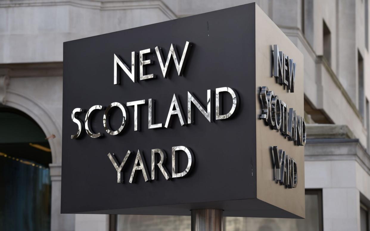 A Scotland Yard detective has been charged with two offences