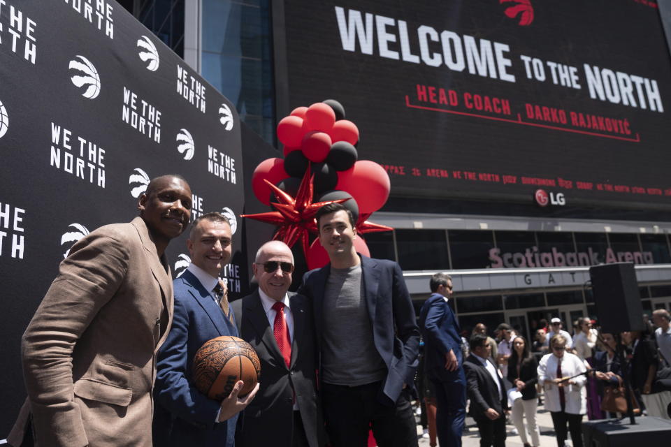 Toronto Raptors NBA basketball team new head coach Darko Rajakovic, center left, poses with team president Masai Ujiri, left, Maple Leaf Sports & Entertainment Ltd. President Larry Tanenbaum, center right, and Raptors general manager Bobby Webster pose following a media availability in Toronto on Tuesday, June 13, 2023. (Chris Young/The Canadian Press via AP)