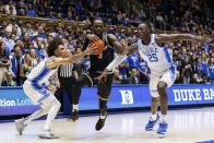 La Salle's Anwar Gill (3) drives as Duke's Tyrese Proctor and Mark Mitchell (25) defend during the first half of an NCAA college basketball game in Durham, N.C., Tuesday, Nov. 21, 2023. (AP Photo/Ben McKeown)