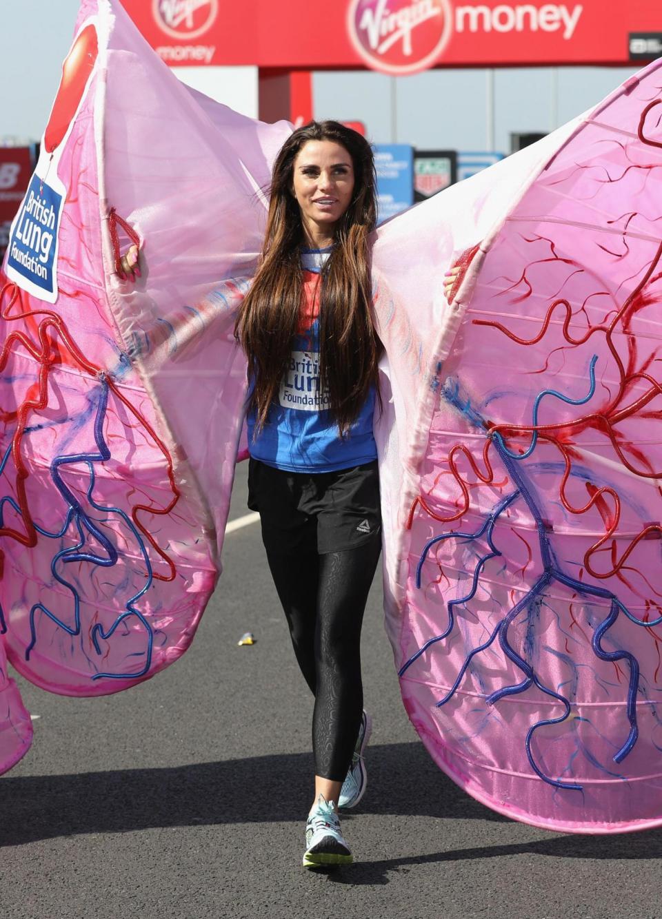 Struggling: Katie Price wearing a giant pair of lungs (Tim P. Whitby/ Getty Images)