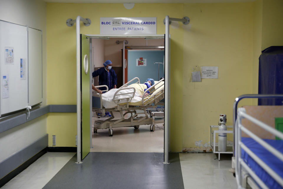 Caroline Erganian, a retired secretary, is taken to her surgery at Bichat Hospital, AP-HP, in Paris, Wednesday, Dec. 2, 2020. (AP Photo/Francois Mori)