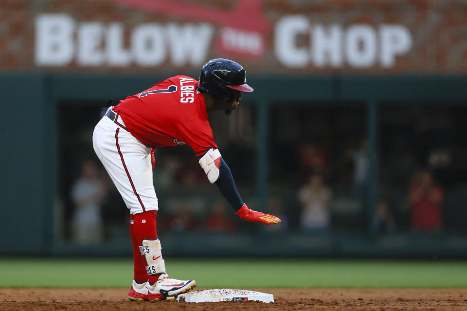 Atlanta Braves' Ozzie Albies reacts after hitting a two-run double during the first inning of the team's baseball game against the Houston Astros, Friday, April 21, 2023, in Atlanta. (AP Photo/Butch Dill)