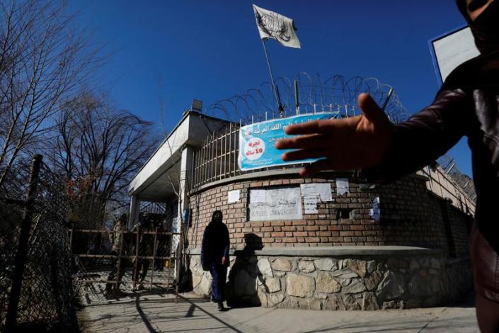 An Afghan student walks in front of the Kabul University in Kabul