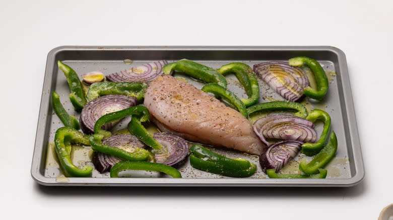 tray with seasoned chicken and vegetables
