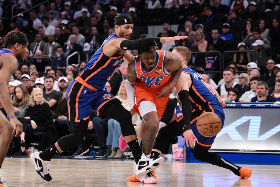 Mar 31, 2024; New York, New York, USA; Oklahoma City Thunder forward Jalen Williams (8) tries to get past New York Knicks guard Josh Hart (3) and New York Knicks guard Donte DiVincenzo (0) during the fourth quarter at Madison Square Garden. Mandatory Credit: John Jones-USA TODAY Sports