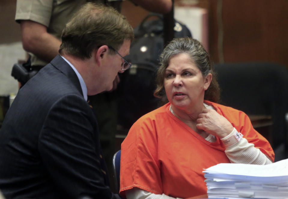 Former Bell assistant city administrator Angela Spaccia talks to her lawyer after she was sentenced in court on Thursday, April 10, 2014, in Los Angeles. Spaccia was sentenced Thursday to nearly 12 years in prison for bilking the Bell's city coffers of thousands of dollars through an exorbitant salary and a pair of six-figure loans of taxpayer money. (AP Photo/Los Angeles Times, Mark Boster, Pool)