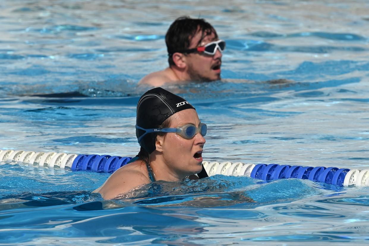 Swimmers in outdoor pool. (Getty Images)