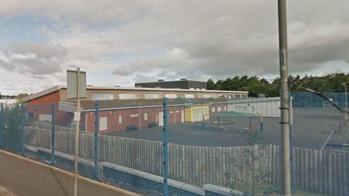 A school building with playground in front