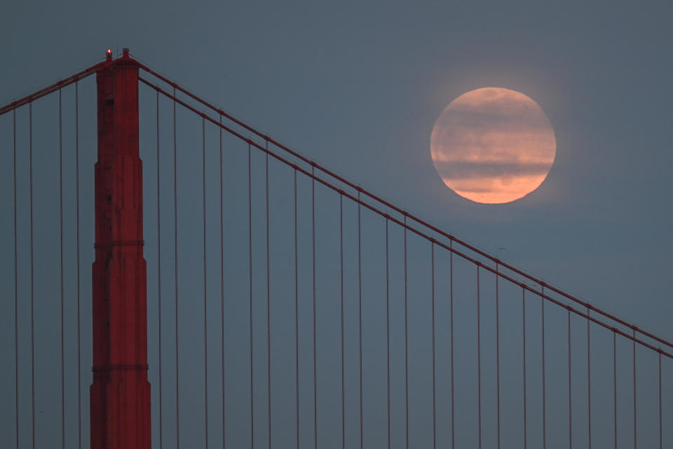 The Pink Moon rises over San Francisco's Golden Gate Bridge on Wednesday, April 5, 2023.