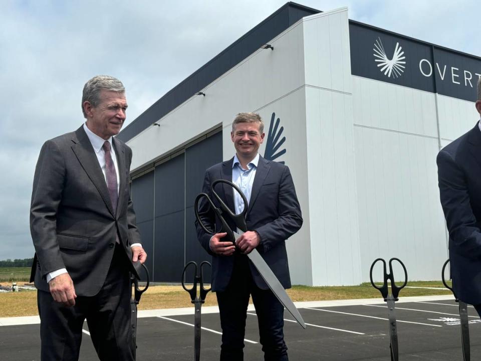 Gov. Roy Cooper (left) stands with Boom Supersonic CEO Blake Scholl on June 17, 2024 after cutting the ribbon on Boom’s first jet factory, a 179,000-square-foot building at the Piedmont Triad International Airport.