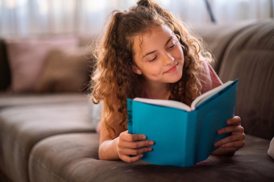 A young girl reading a book