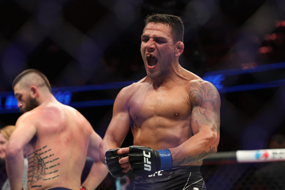 Dec 3, 2022; Orlando, Florida, USA; Rafael Dos Anjos (blue gloves) reacts after fighting Bryan Barberena (red gloves) during UFC Fight Night at Amway Center. Mandatory Credit: Nathan Ray Seebeck-USA TODAY Sports