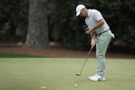Rory McIlroy, of Northern Ireland, looks at his notes on the 10th green during a practice round in preparation for the Masters golf tournament at Augusta National Golf Club Tuesday, April 9, 2024, in Augusta, Ga. (AP Photo/Ashley Landis)