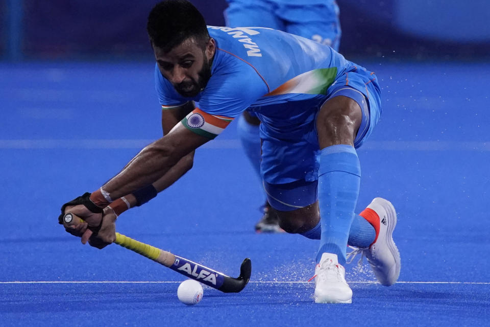 India's Manpreet Singh (7) passes against Japan during a men's field hockey match at the 2020 Summer Olympics, Friday, July 30, 2021, in Tokyo, Japan. (AP Photo/John Locher)