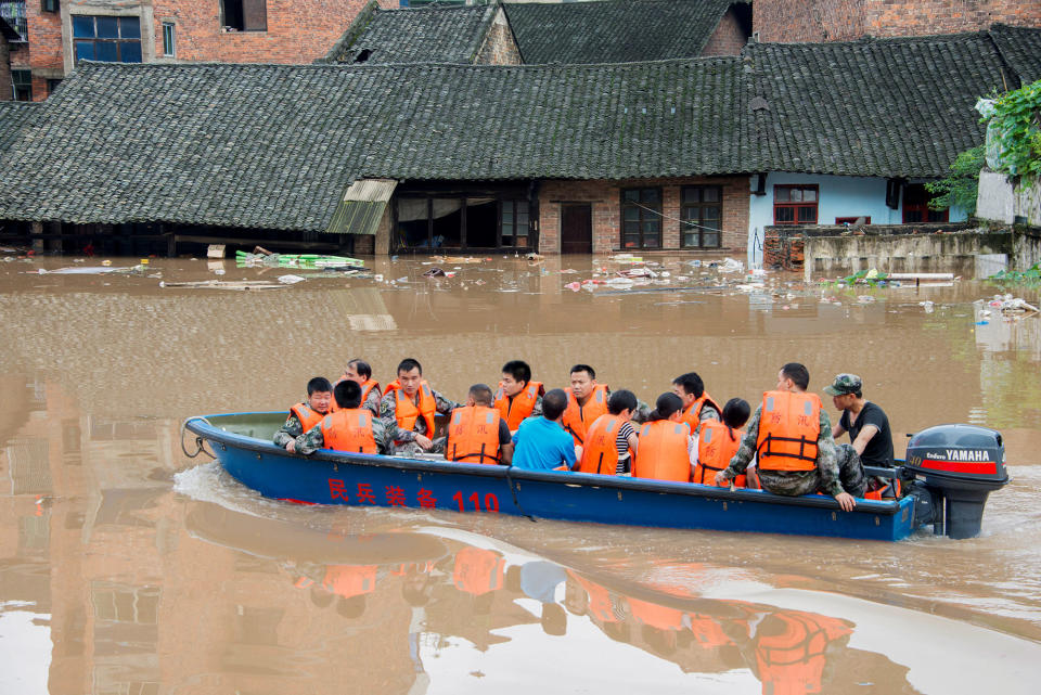 Rescuers evacuate people