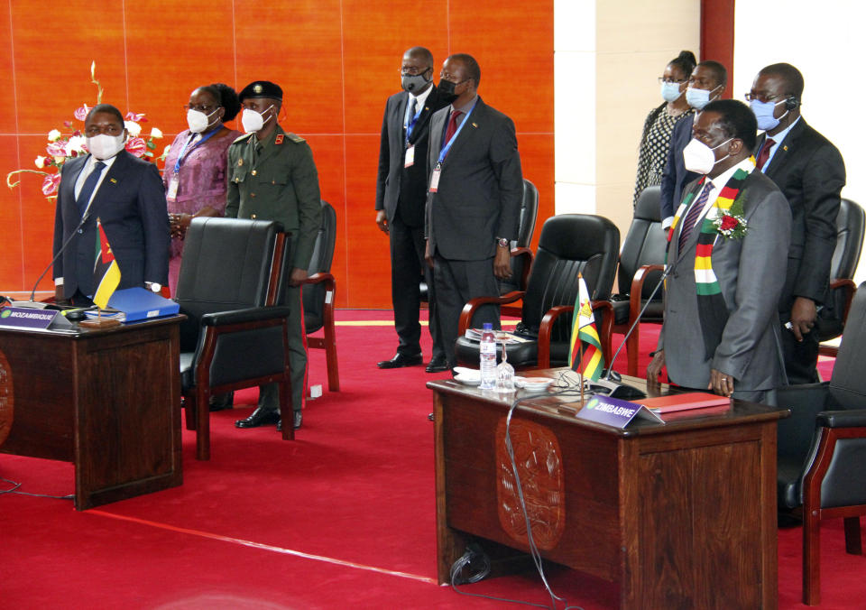 Mozambican President Filipe Nyusi, left, and Zimbabwe President Emmerson Mnangagwe, right, join Southern African leaders during a meeting in Mozambique's capital Maputo, Thursday, April 8, 2021. Leaders met to discuss ways to respond to the violence by Islamic extremist rebels in the country's northern Cabo Delgado province where thousands of people have been killed and displaced. (AP Photo/Ferhat Momade)