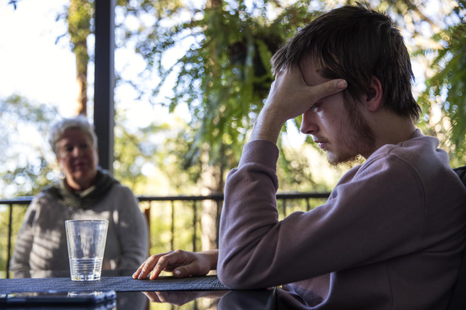 Deb Ware, left, urges her son, Sam, to go to rehab upon letting him return to her home for the first time since he last overdosed there three weeks earlier, in Fountaindale, Central Coast, Australia, Friday, July 19, 2019. But he doesn't like rehab, he says. He doesn't like the people who go there. He doesn't like the rules. And there's something else. "What if it doesn't work?" he asks. "You haven't tried!" she snaps. (AP Photo/David Goldman)