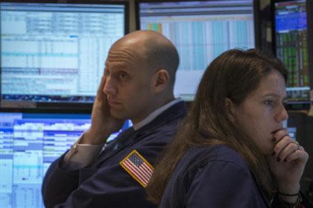 Traders work on the floor of the New York Stock Exchange February 4, 2014. REUTERS/Brendan McDermid